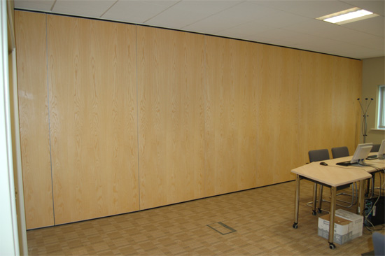 The is an maple finished folding partition wall. Most suitable to separate meeting rooms or create one large meeting area when open.